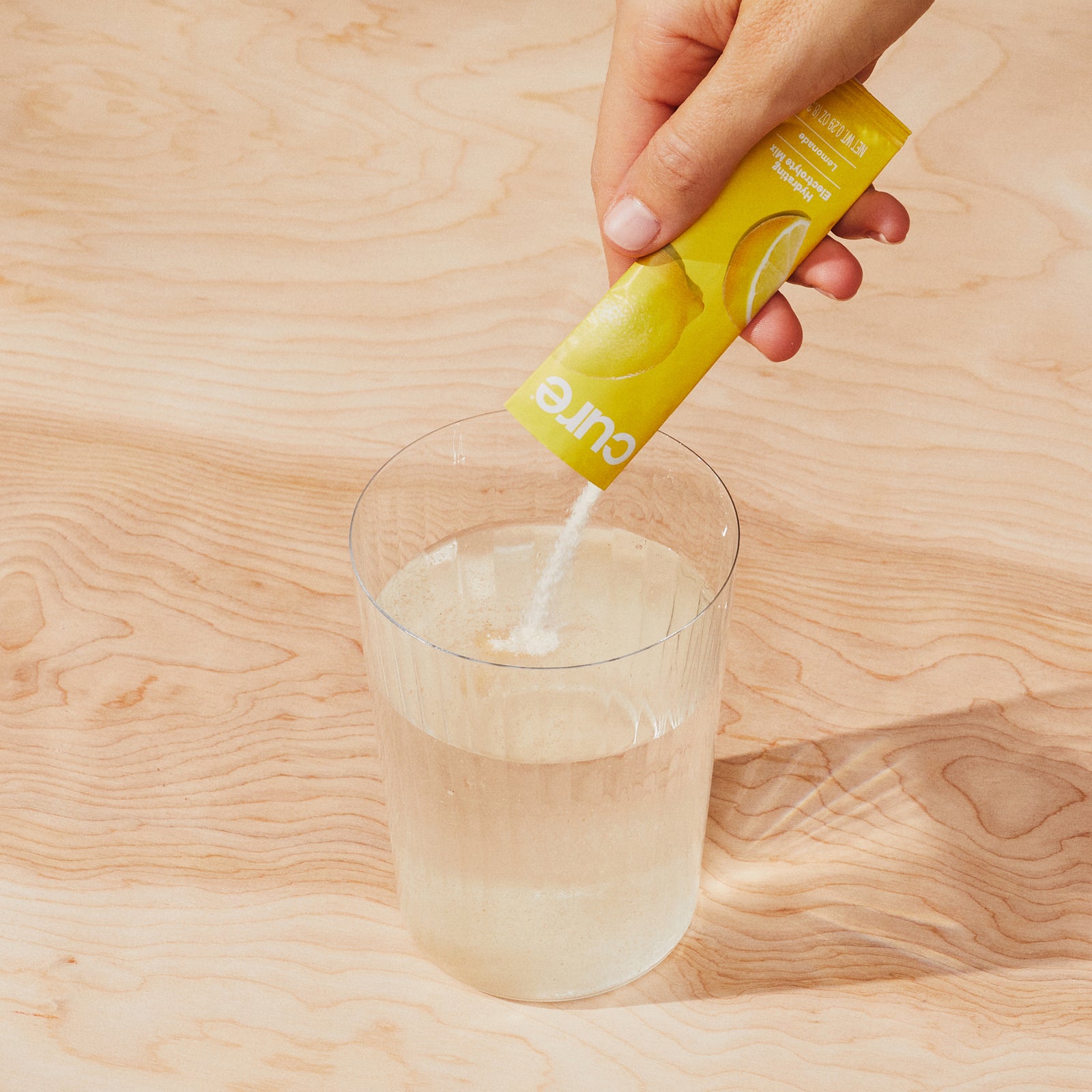 Pouring 'cure' into water.