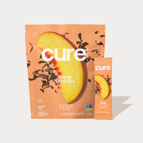 Cure Energy Drink Mix Peach Tea flavor packet and pouch with a peach slice image on the packaging
